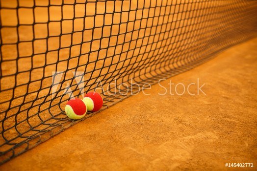 Picture of Tennis red ball on a clay tennis court orange color